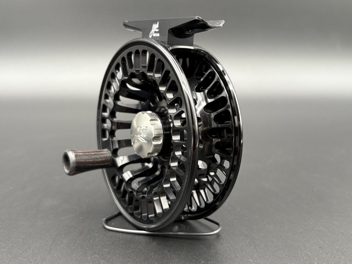 Abel TR Fly Reels in Black with classic click-pawl design - angled