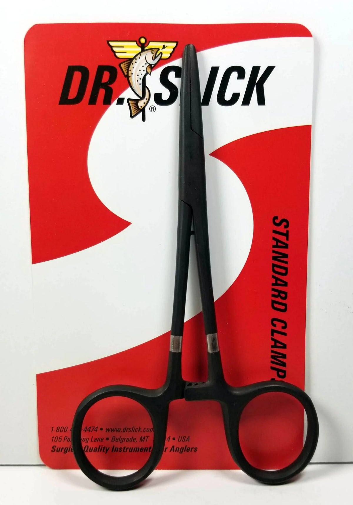 Black clamp scissors on a red and white Dr. Stick packaging background